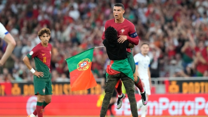 Trận đấu tối 17/6 bị gián đoạn vì CĐV chạy vào sân ôm Ronaldo. Ảnh: AP