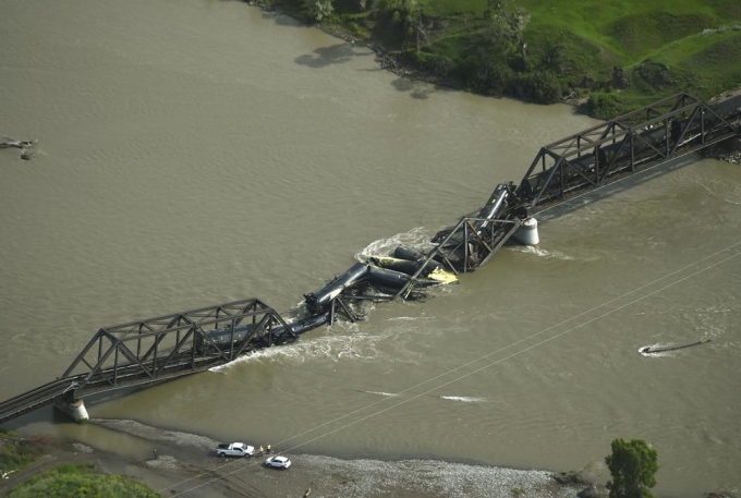 Portions of a freight train are seen in the Yellowstone River after an overnight railroad bridge collapse, near Columbus, Mont., Saturday, June 24, 2023.