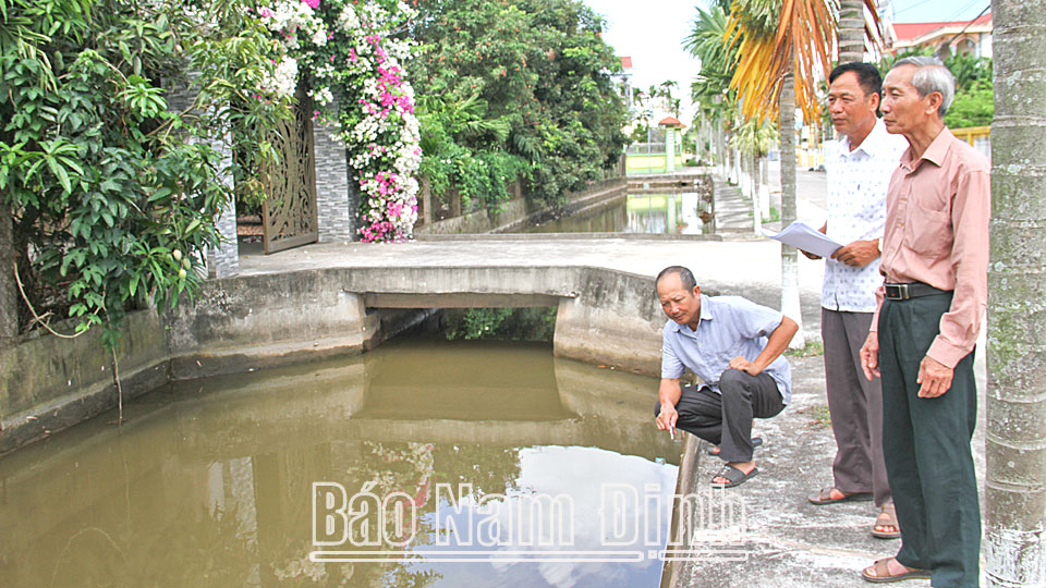 Bác Nguyễn Thanh Hoà (đứng ngoài cùng, bên phải), Bí thư Chi bộ 2 Phú Lễ, xã Hải Châu (Hải Hậu) cùng các đồng chí trong Ban Chi ủy kiểm tra công trình kè mương dẫn nước.