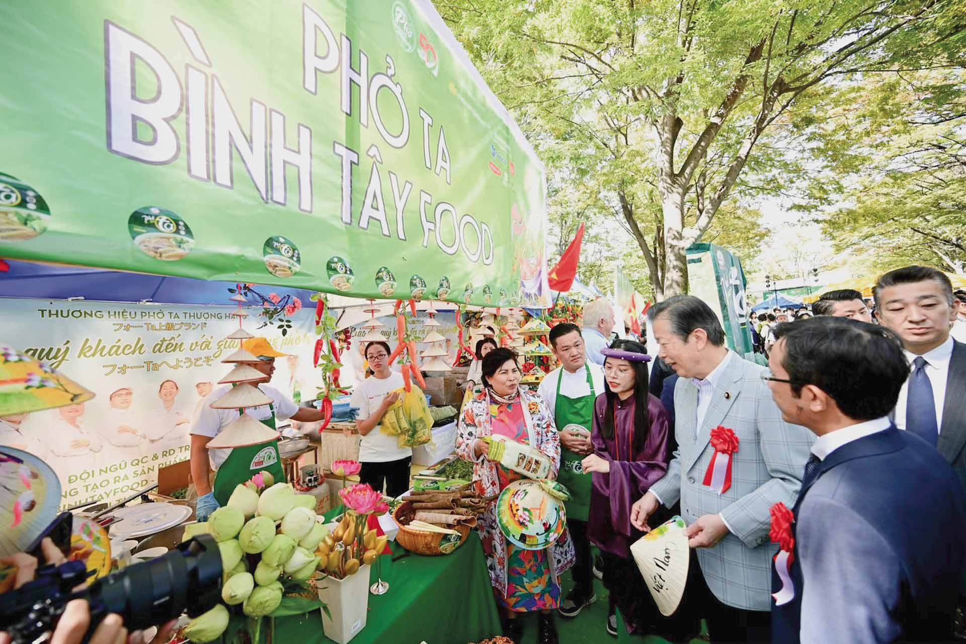 Thực khách xếp hàng và thưởng thức phở. (Ảnh: Quang Định)