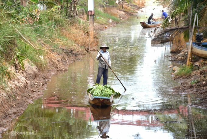 Nước tại các tuyến kênh khô cạn gần sát đáy khiến việc vận chuyển nông sản của nông dân gặp khó khăn. Ảnh: An Minh