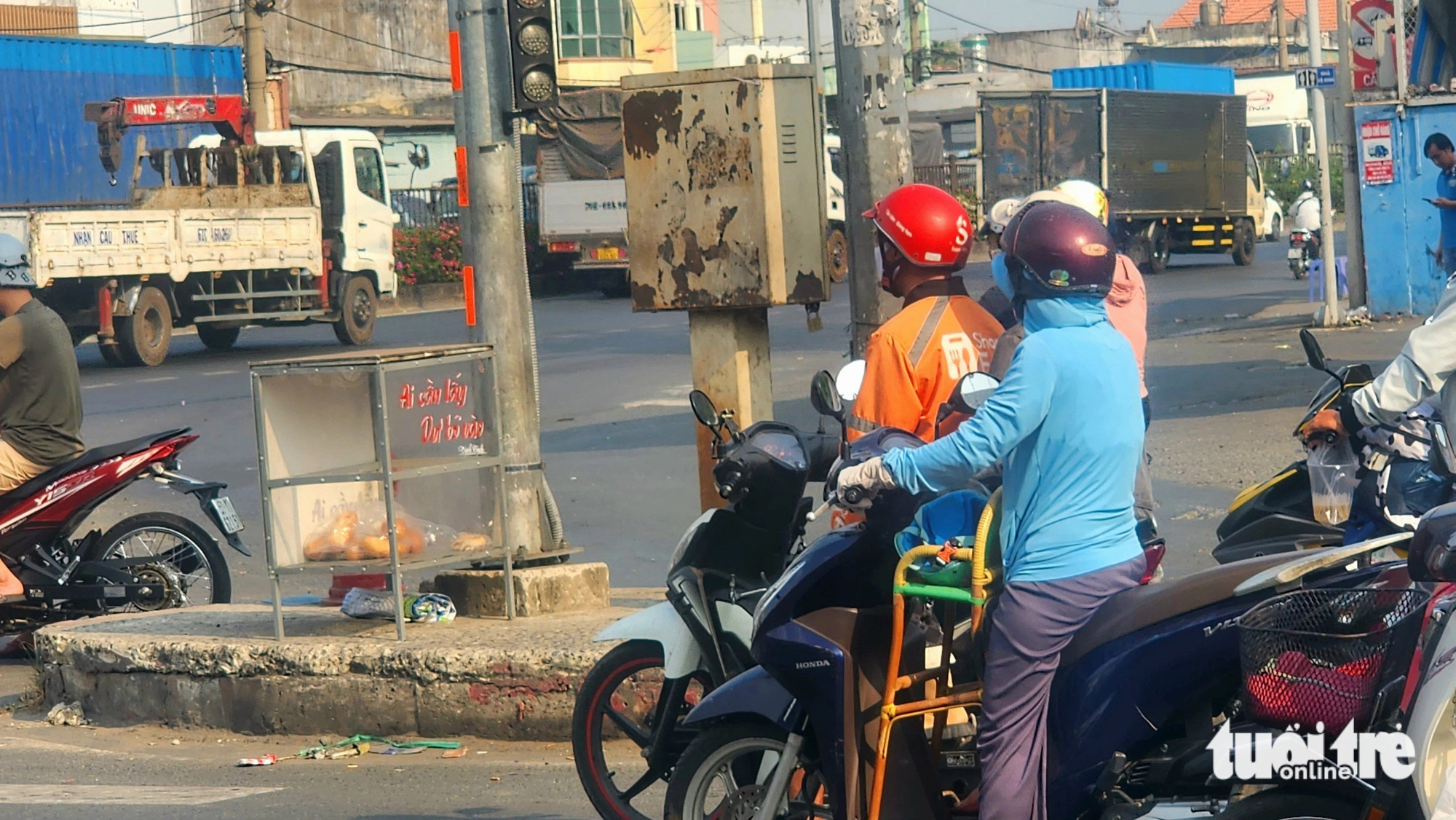 Chiếc tủ có dòng chữ 'ai cần lấy, dư bỏ vào' đặt gần đèn giao thông tại khu vực giao lộ Nguyễn Văn Bứa - quốc lộ 22 (huyện Hóc Môn) - Ảnh: NGỌC KHẢI