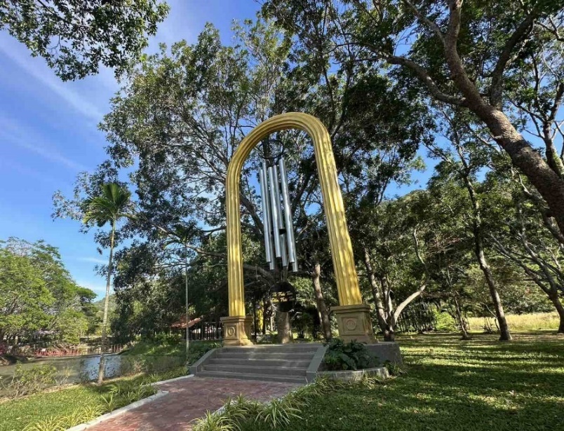 A large wind chimes in a park  Description automatically generated