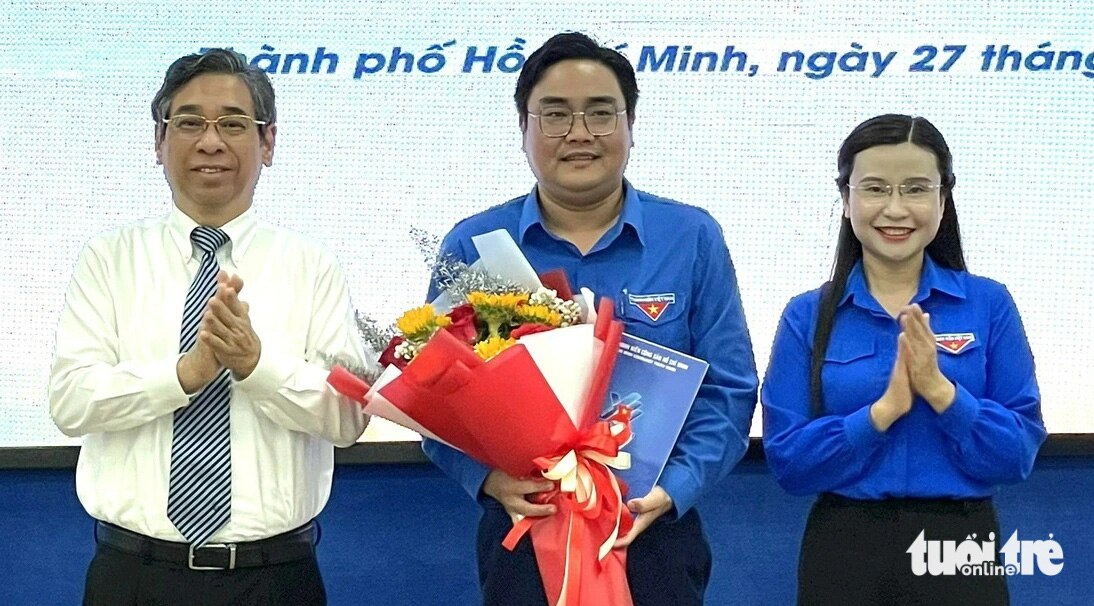 Phó bí thư Thành ủy TP.HCM Nguyễn Phước Lộc (bìa trái) cùng Bí thư Trung ương Đoàn Nguyễn Phạm Duy Trang (bìa phải) trao quyết định, tặng hoa chúc mừng tân Bí thư Thành Đoàn TP.HCM Ngô Minh Hải - Ảnh: K.ANH