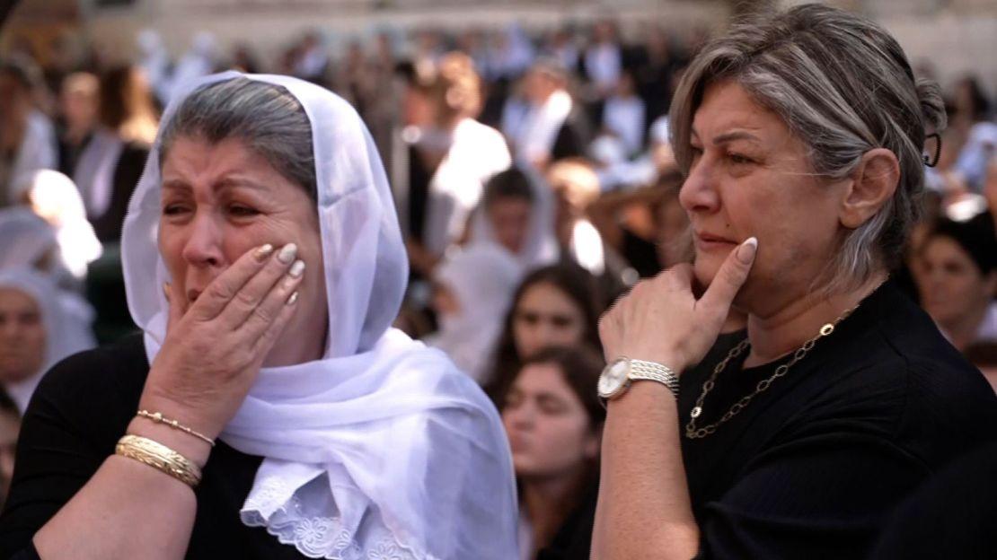 Women shocked and in mourning after 12 children were killed in the once quiet village of Majdal Shams.