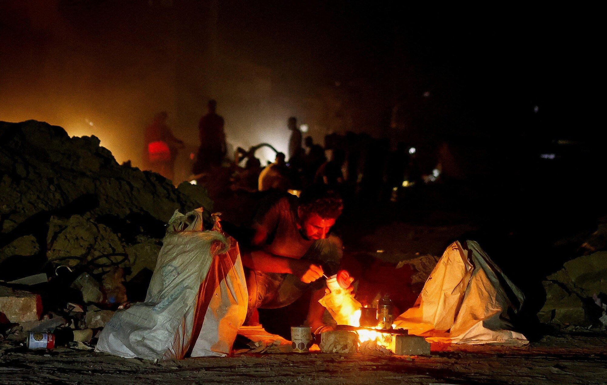 Palestinians walk after they were ordered by Israeli army to evacuate their neighbourhood's, in Khan Younis