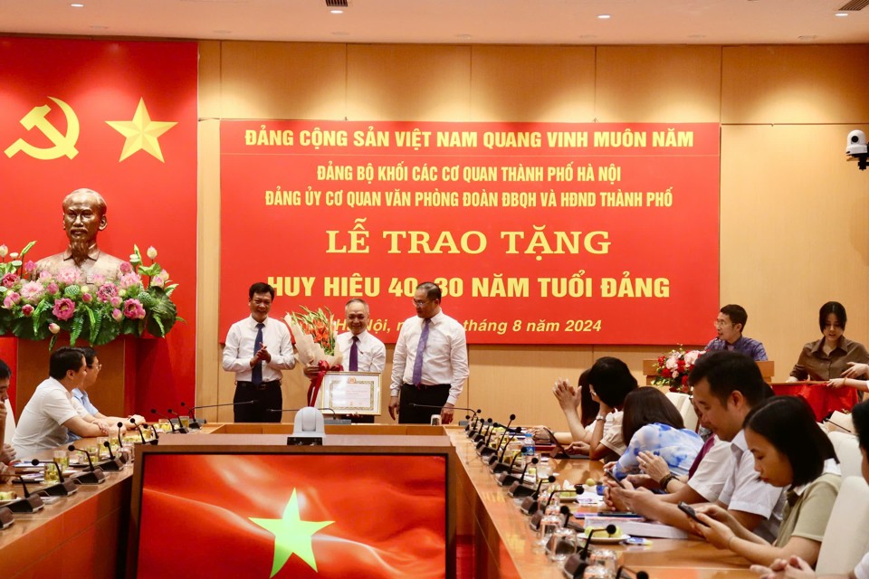 Phó Bí thư Thường trực Đảng uỷ Khối Phùng Khải Lợi trao Huy hiệu đảng 40 năm cho đảng viên Vũ Quang Chinh