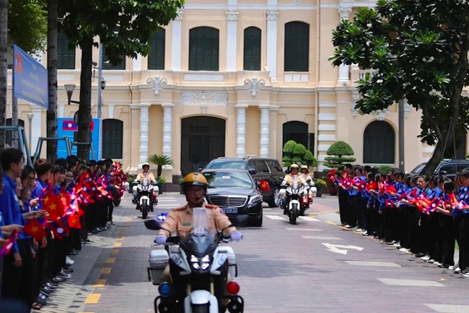 Đoàn xe hộ tống Tổng Bí thư, Chủ tịch nước Lào Thongloun Sisoulith đến Khách sạn REX (quận 1), trong sự đón chào của thanh niên TP Hồ Chí Minh