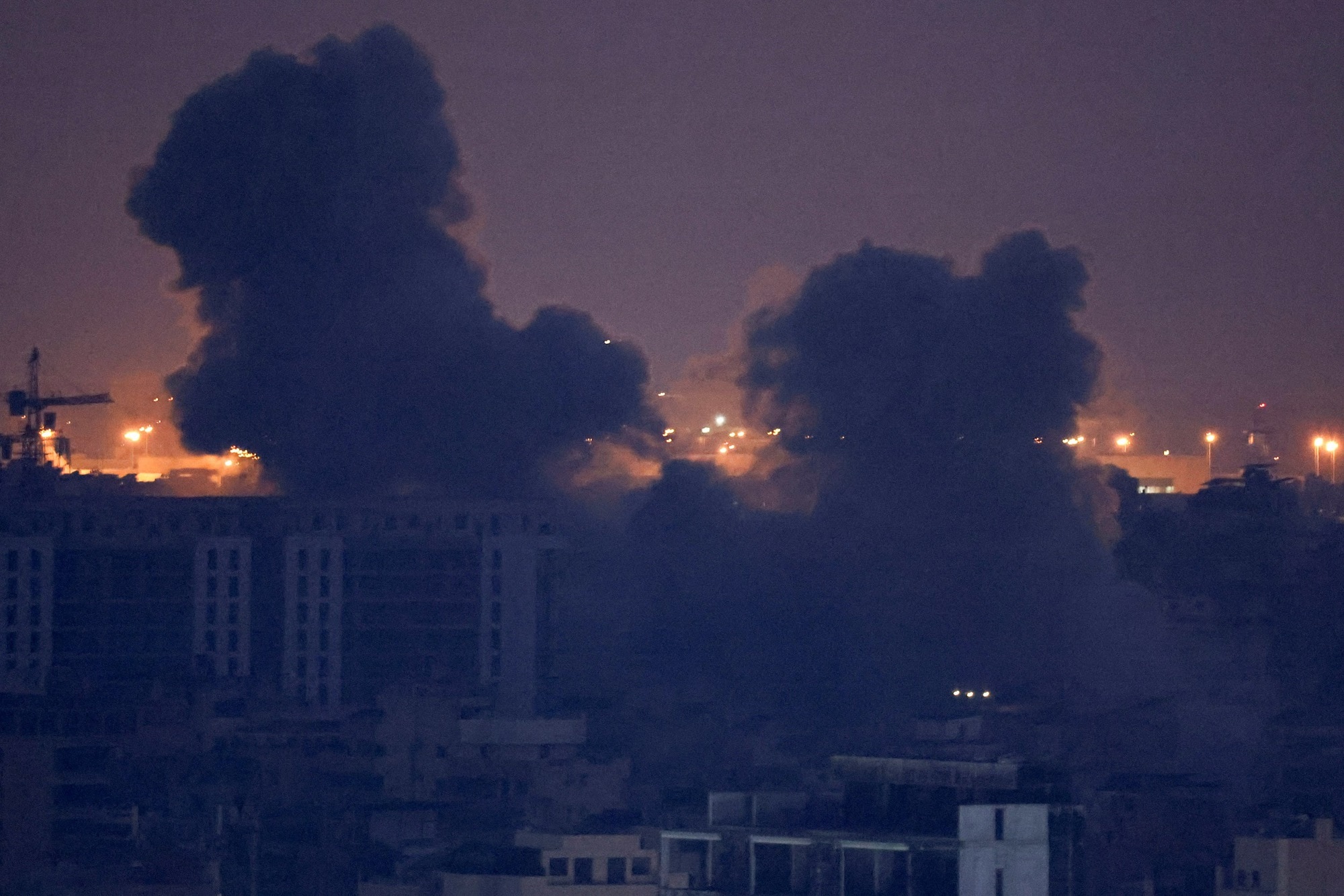 Smoke rises in Beirut's southern suburbs after a strike, as seen from Sin El Fil