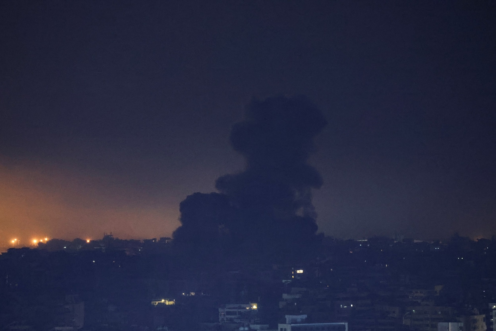 Smoke billows over Beirut southern suburbs after a strike, as seen from Sin El Fil