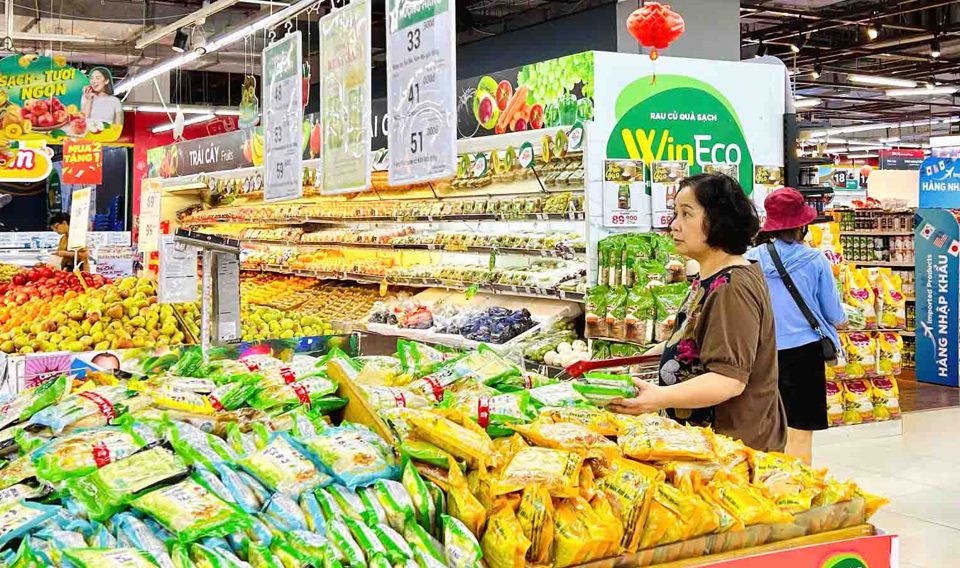 Người ti&ecirc;u d&ugrave;ng mua h&agrave;ng h&oacute;a trước thềm năm mới 2025 tại si&ecirc;u thị Winmart. Ảnh: Ho&agrave;i Nam