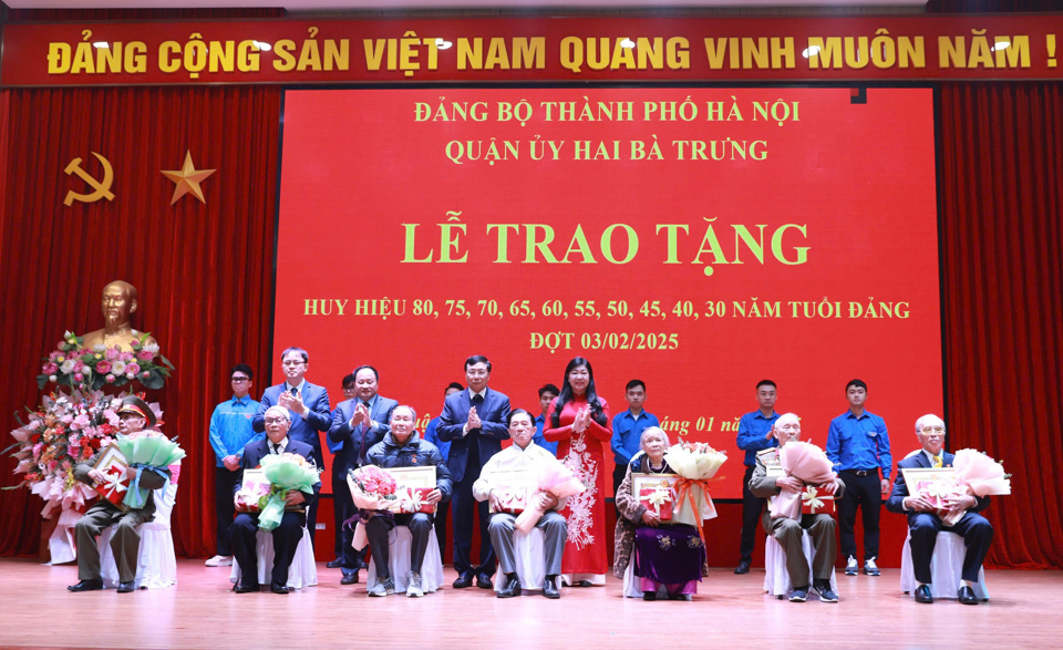 Chủ tịch Ủy ban MTTQ Việt Nam TP Hà Nội Nguyễn Lan Hương trân trọng trao và gắn Huy hiệu 75 năm, 70 năm tuổi Đảng tặng các đảng viên; các đồng chí trong Thường trực Quận ủy Hai Bà Trưng trao tặng quà tới các đảng viên